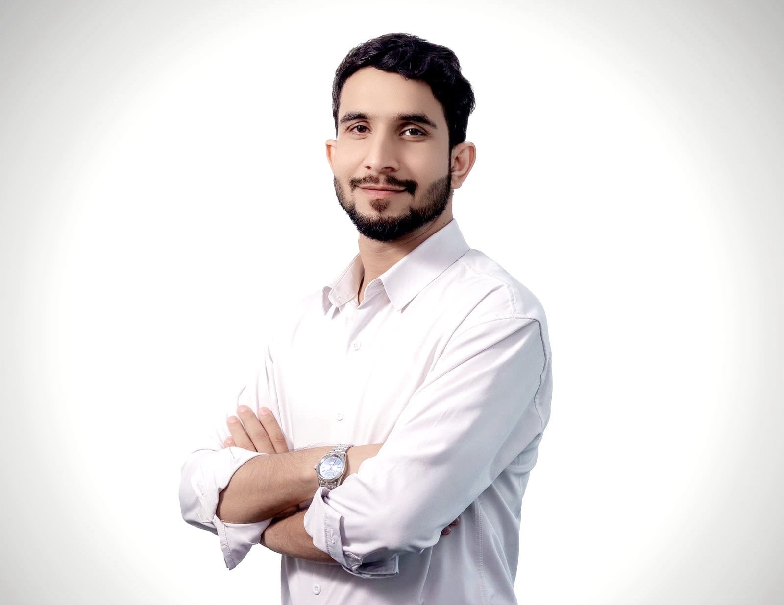 Saqib Rind, Founder, in a white shirt with arms folded